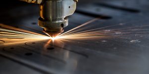 Cutting of metal. Sparks fly from laser, close-up